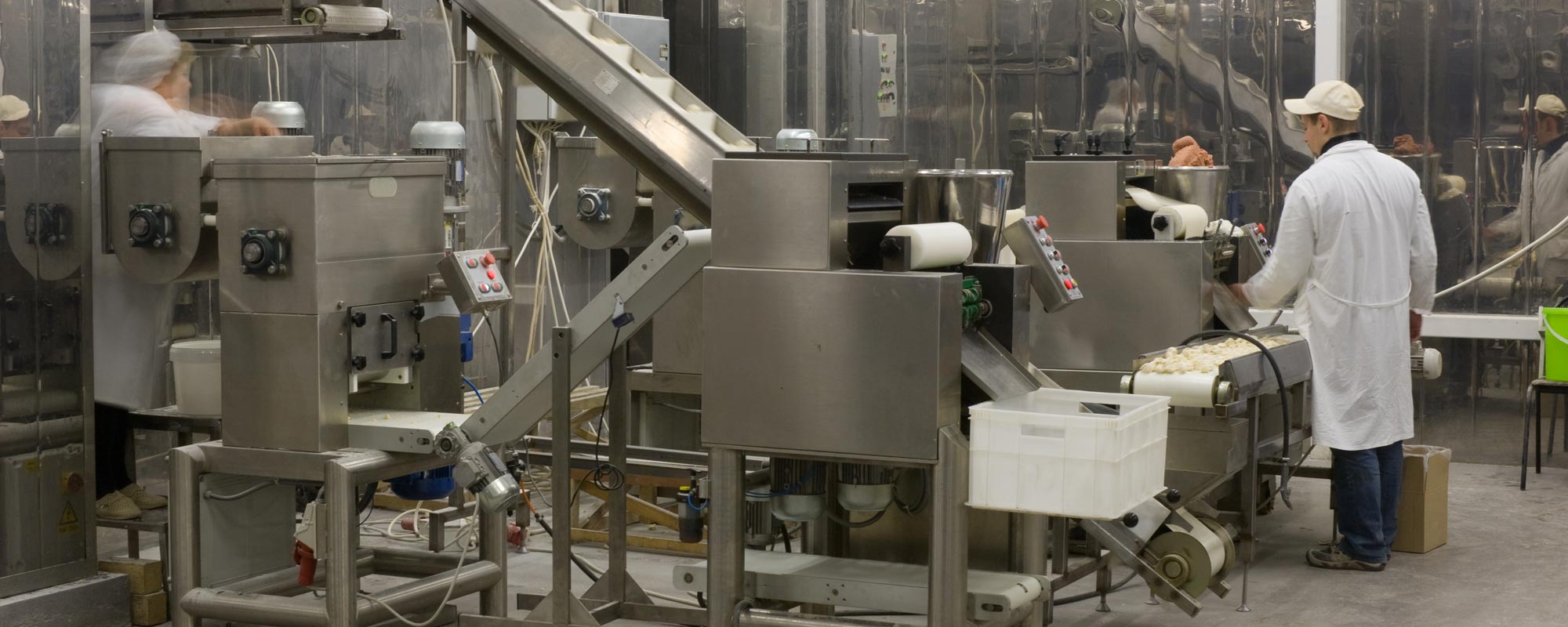Automated production line in modern food factory. Ravioli production. People working.